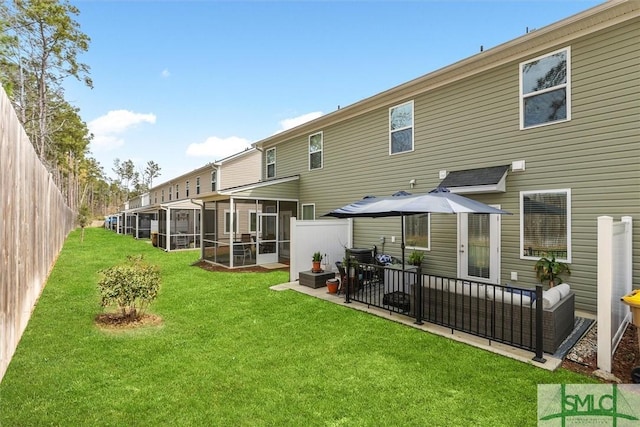 back of property with a yard, an outdoor hangout area, and a sunroom