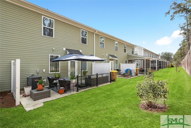 back of house with a yard, central AC unit, a patio, and a sunroom