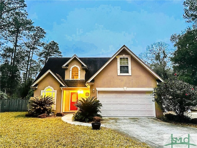 view of front facade with a garage and a front lawn