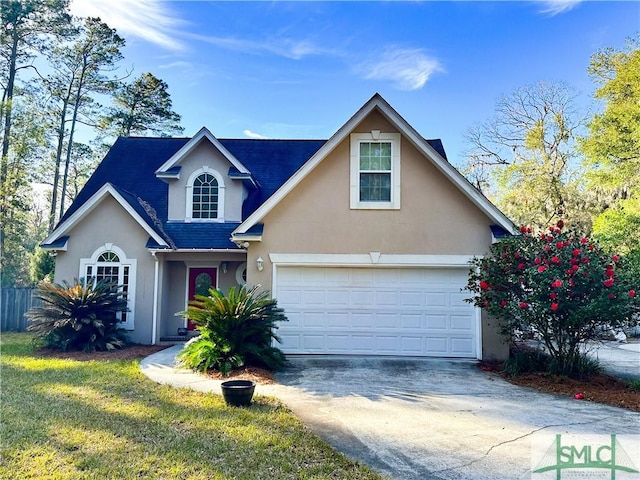 traditional home with a garage, driveway, and stucco siding