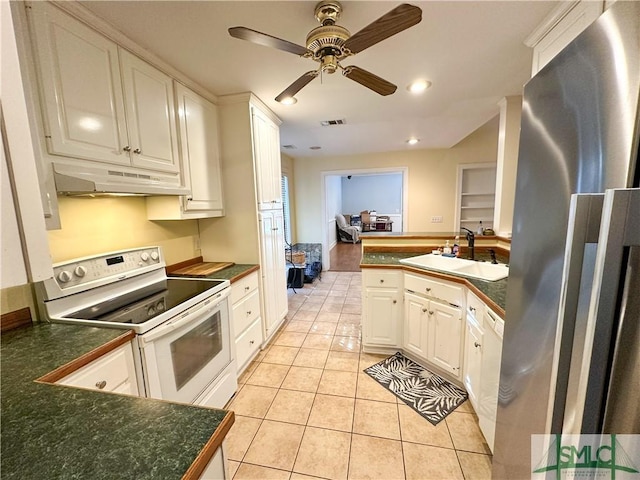 kitchen featuring under cabinet range hood, white appliances, a sink, visible vents, and white cabinets