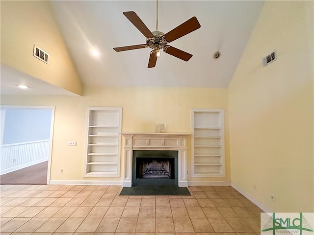 unfurnished living room with a fireplace with flush hearth, built in shelves, and visible vents