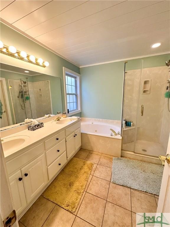 bathroom featuring double vanity, a bath, tile patterned floors, a shower stall, and a sink