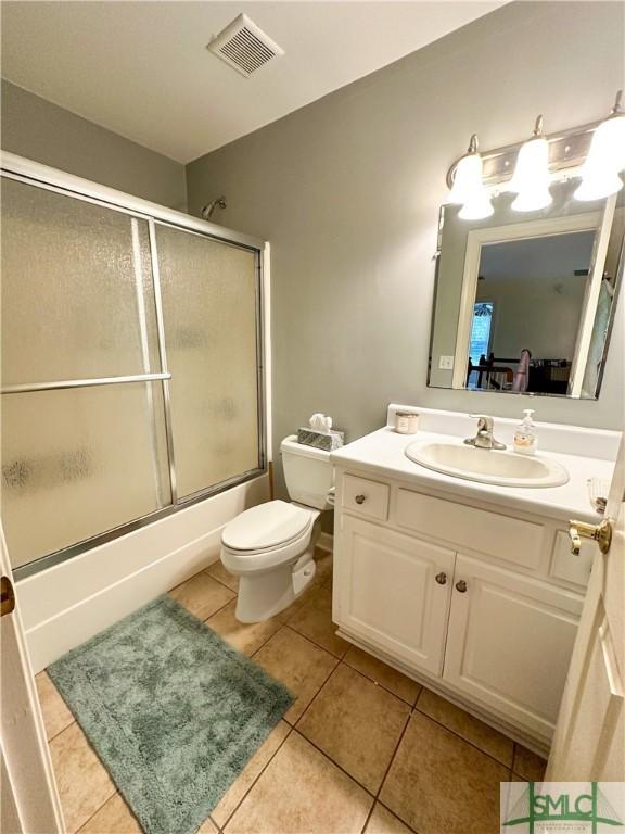 full bath featuring visible vents, toilet, enclosed tub / shower combo, tile patterned flooring, and vanity