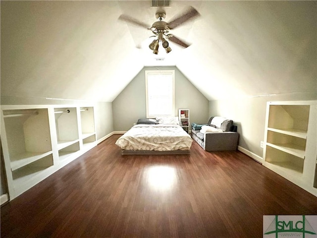 unfurnished bedroom featuring lofted ceiling, visible vents, dark wood-type flooring, ceiling fan, and baseboards