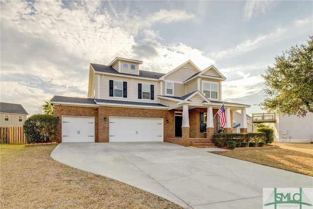 craftsman inspired home with a garage, a porch, and a front yard