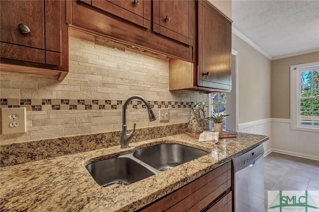 kitchen with sink, stainless steel dishwasher, crown molding, light stone countertops, and a textured ceiling