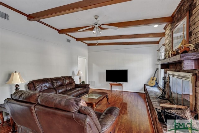 living room with beam ceiling, ceiling fan, dark hardwood / wood-style floors, and a fireplace