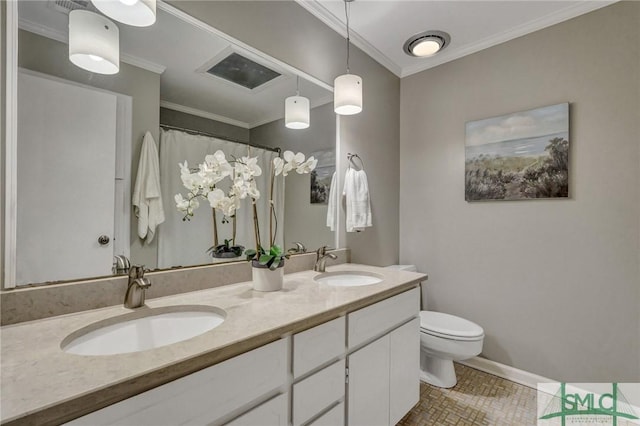 bathroom featuring vanity, ornamental molding, and toilet