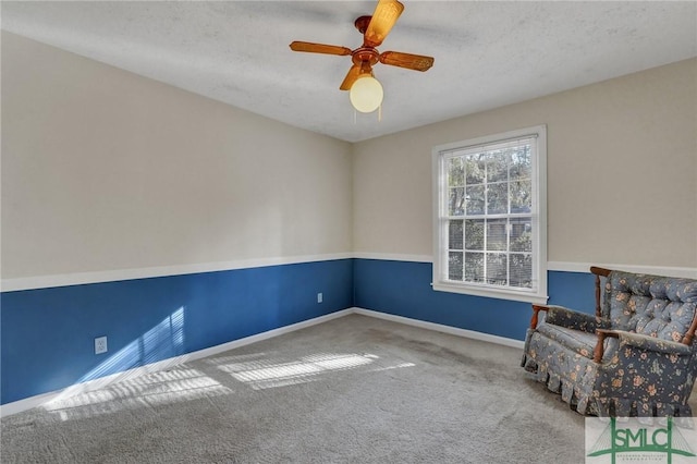 unfurnished room with a textured ceiling, carpet floors, and ceiling fan