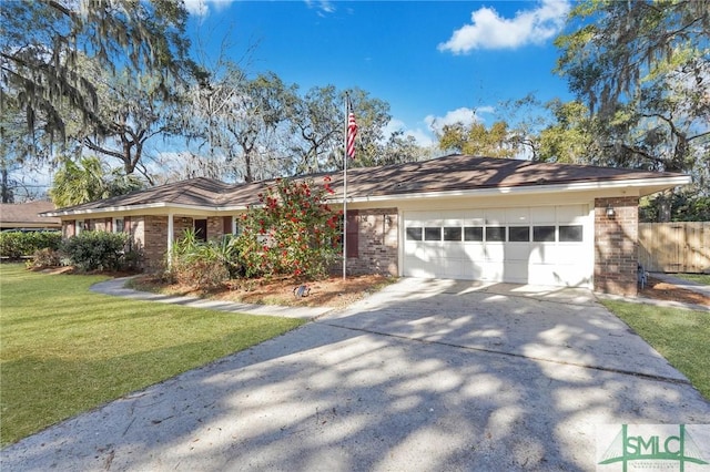 single story home featuring a garage and a front lawn