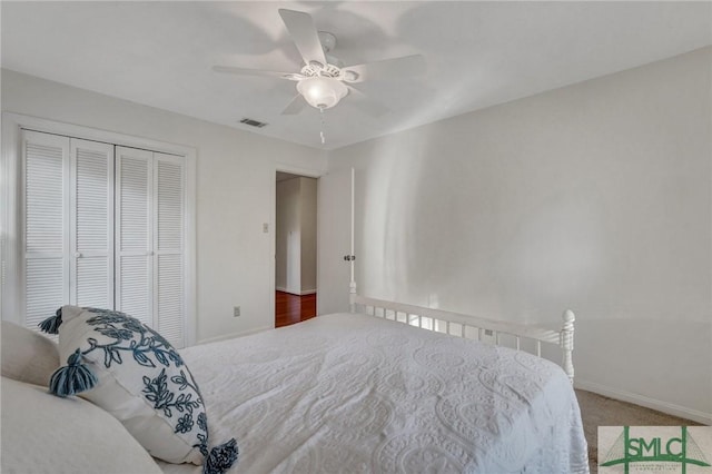 carpeted bedroom featuring a closet and ceiling fan