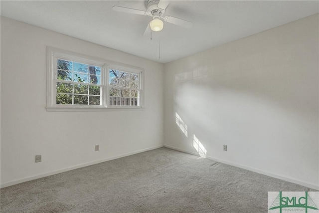 spare room with light colored carpet and ceiling fan