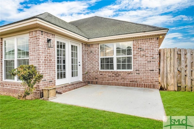 back of property featuring a yard and a patio area