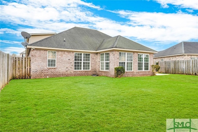 rear view of house with a lawn