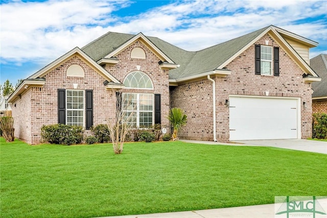 view of property featuring a garage and a front yard