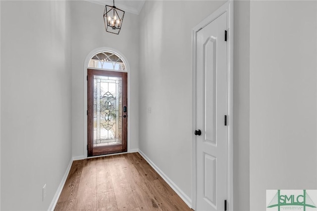 foyer featuring an inviting chandelier and light hardwood / wood-style floors