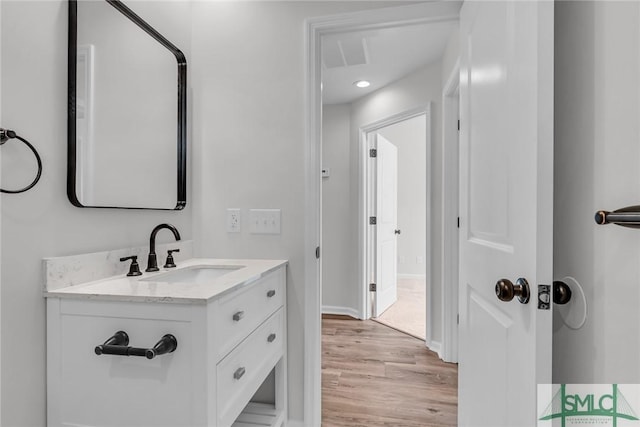 bathroom featuring vanity and hardwood / wood-style floors