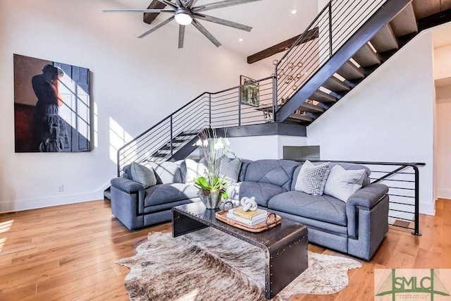 living room featuring hardwood / wood-style flooring and a high ceiling