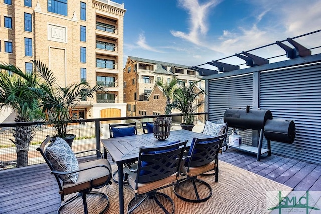 wooden deck featuring a grill and a pergola