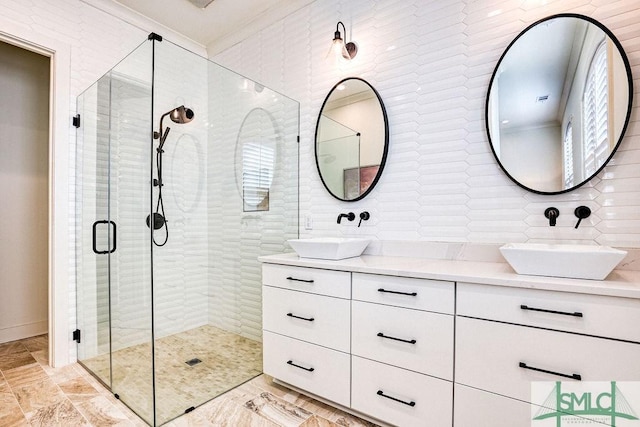 bathroom featuring ornamental molding, vanity, and a shower with door