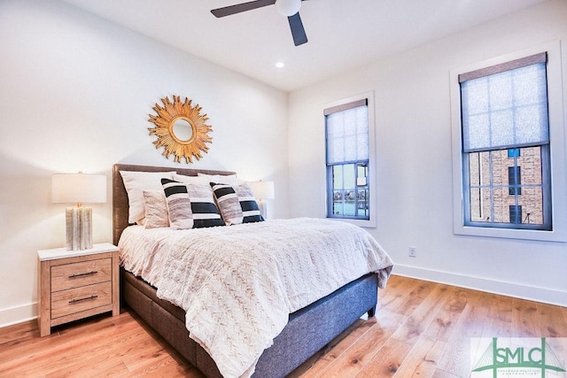 bedroom with ceiling fan and light hardwood / wood-style floors