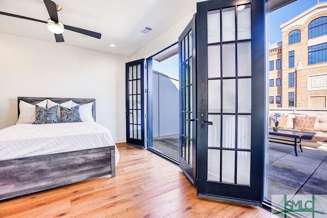 bedroom featuring hardwood / wood-style flooring, french doors, and ceiling fan