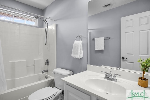 full bathroom featuring vanity, tub / shower combination, and toilet