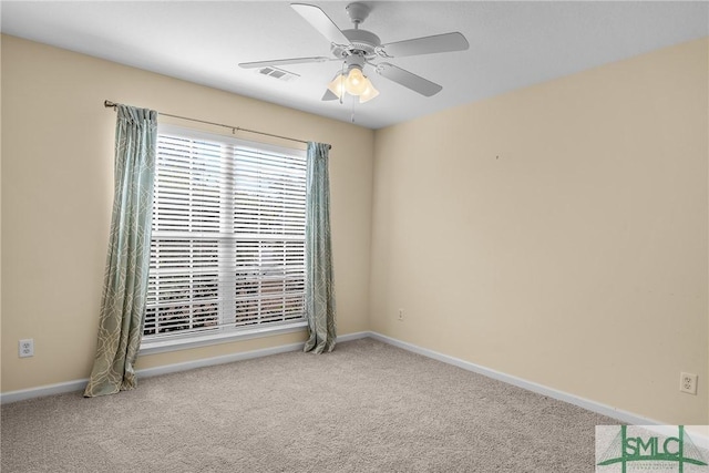 carpeted spare room featuring ceiling fan