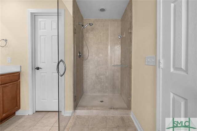 bathroom with vanity, an enclosed shower, and tile patterned floors