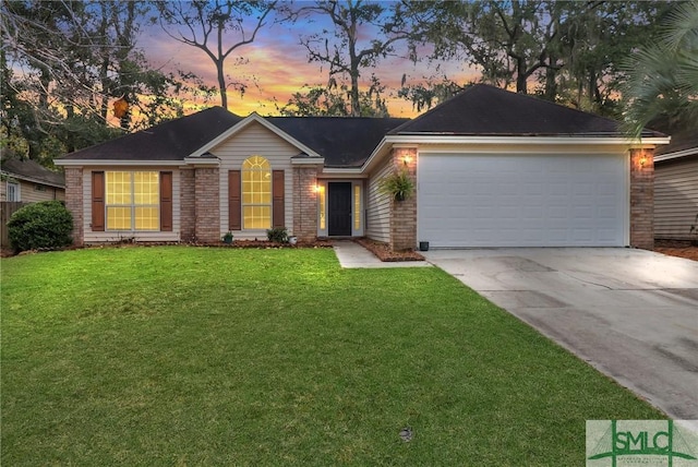 ranch-style home with a garage and a yard