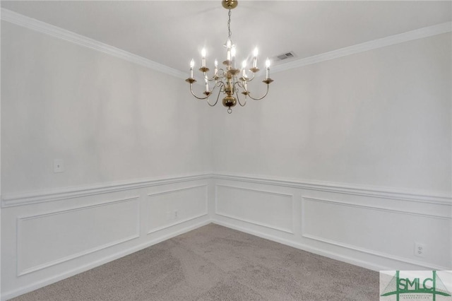 spare room with ornamental molding, light carpet, and a chandelier