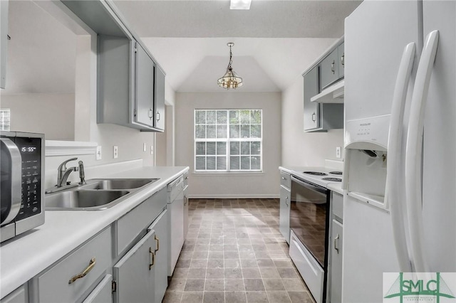 kitchen with gray cabinets, lofted ceiling, sink, hanging light fixtures, and white appliances