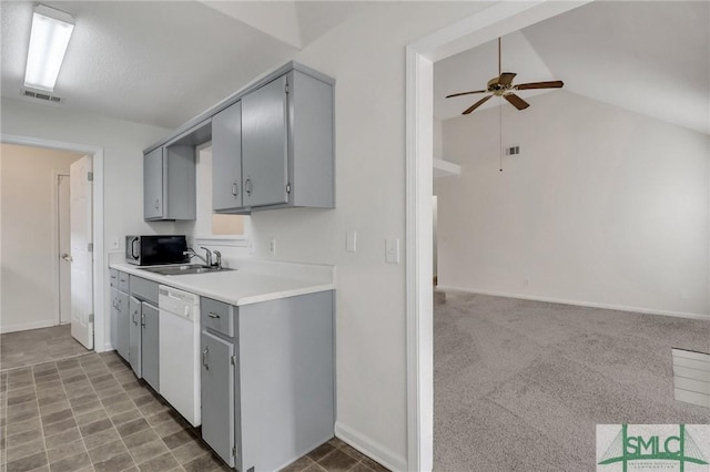 kitchen featuring lofted ceiling, sink, ceiling fan, gray cabinetry, and white dishwasher