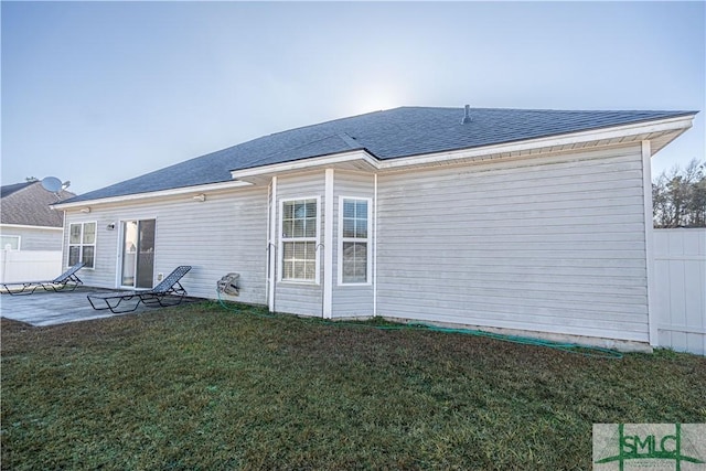 back of property with a patio and a lawn