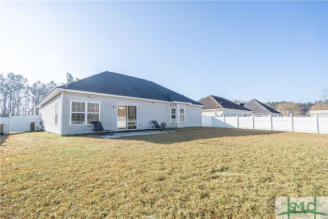 rear view of house with central AC unit, a lawn, and a patio area