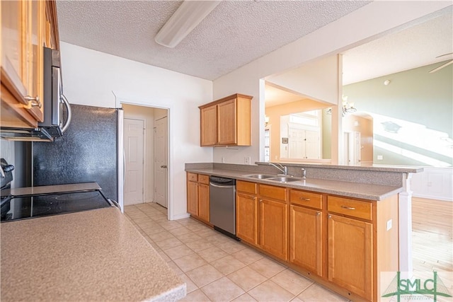 kitchen featuring stainless steel appliances, light tile patterned flooring, sink, and a textured ceiling