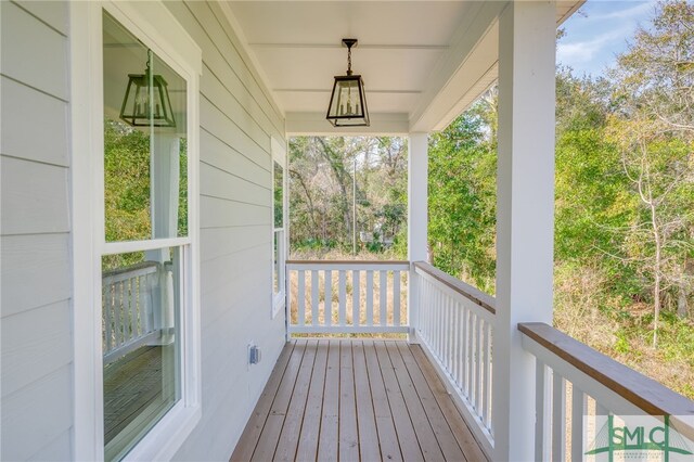 wooden terrace featuring covered porch