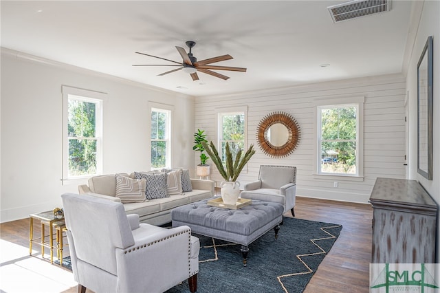 living room featuring baseboards, dark wood finished floors, visible vents, and a ceiling fan