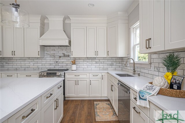 kitchen with dark wood finished floors, custom range hood, stainless steel dishwasher, white cabinetry, and a sink