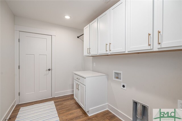 clothes washing area with dark wood finished floors, hookup for a washing machine, cabinet space, and hookup for an electric dryer