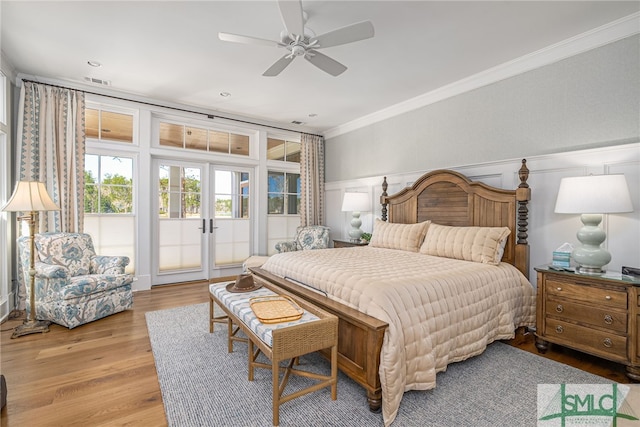 bedroom featuring light hardwood / wood-style flooring, ornamental molding, access to outside, ceiling fan, and french doors