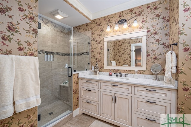 bathroom featuring vanity and a shower with door