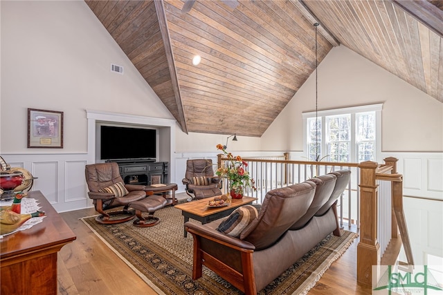 living room with wood-type flooring, high vaulted ceiling, and wood ceiling