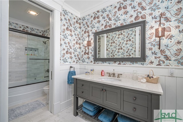 full bathroom featuring vanity, ornamental molding, toilet, and combined bath / shower with glass door