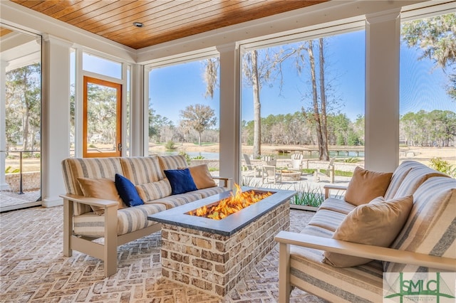 sunroom / solarium featuring wood ceiling