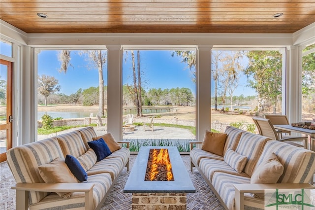 sunroom with a water view and wooden ceiling