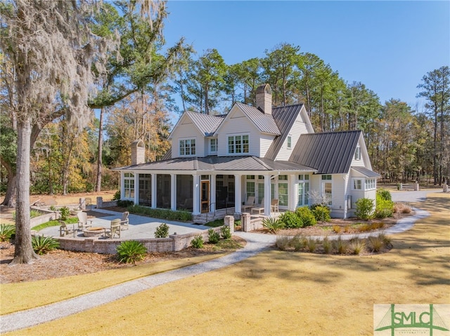 back of house with a patio area and a sunroom