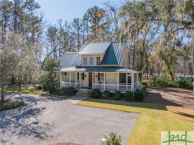 farmhouse-style home featuring a front yard and covered porch