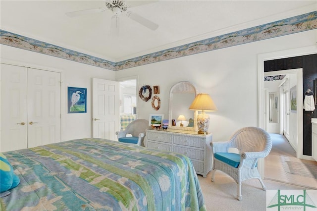 carpeted bedroom featuring a closet and ceiling fan